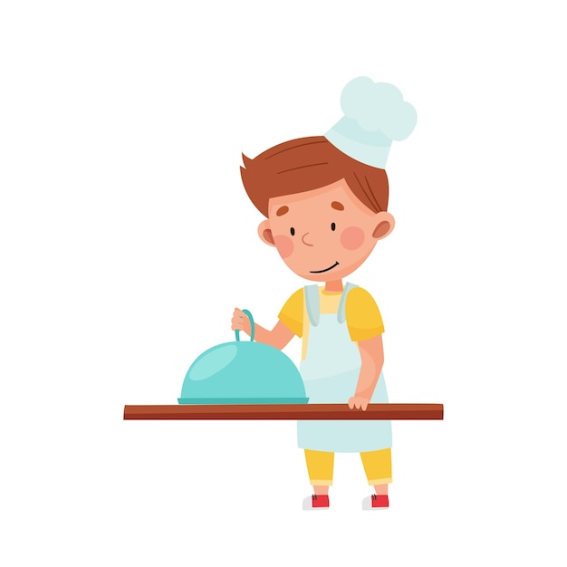 Kleine jongen personage in hoed en schort staan aan de keukentafel koken schotel Vector illustratie