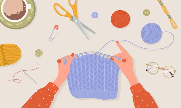 knitting process. female hands with needles and thread.