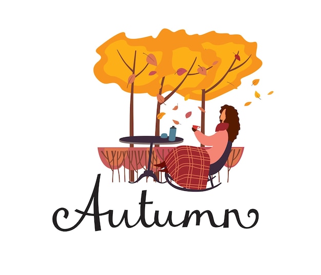 Lettering autumn una donna si siede sotto un plaid su una sedia di cobber in giardino e beve il tè