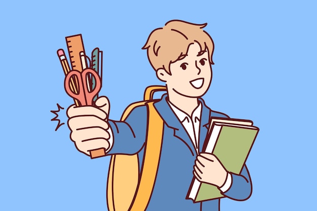 Little boy from primary school with smile demonstrates stationery and books standing with backpack