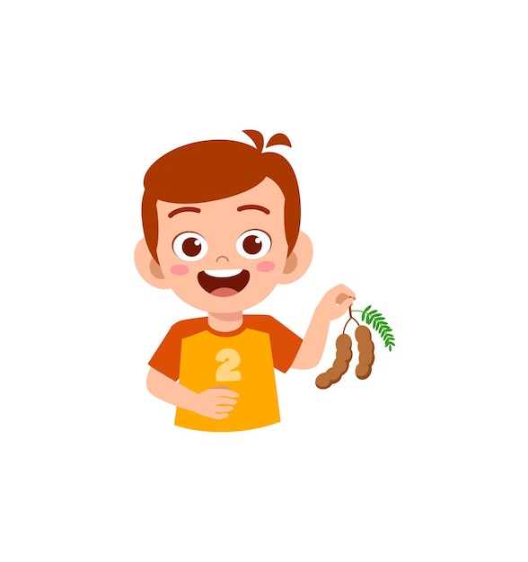 Little boy holding fresh tamarind fruit from farm