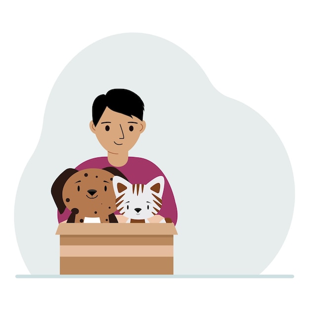 Маленький мальчик держит картонную коробку с кошкой и собакой Концепция спасательной помощи и ухода за домашними животными