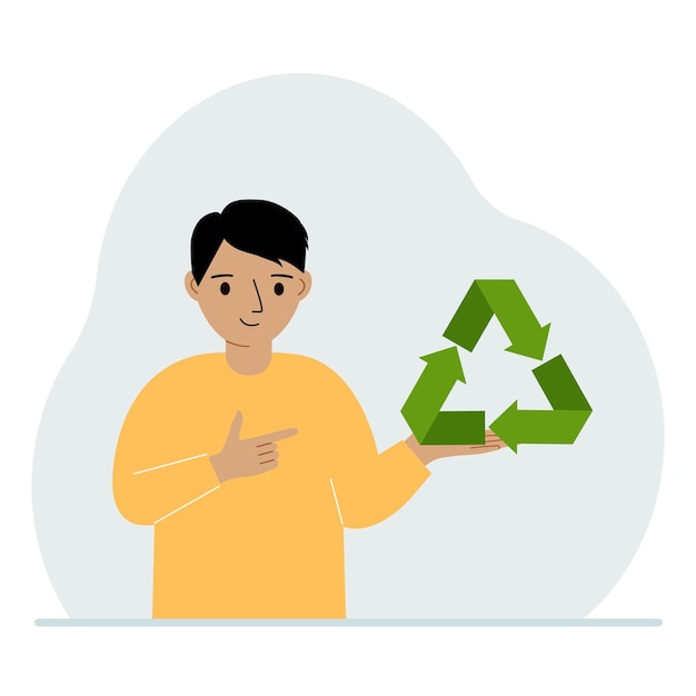 A little boy is holding a green recycle recycling or ecology sign in his hands