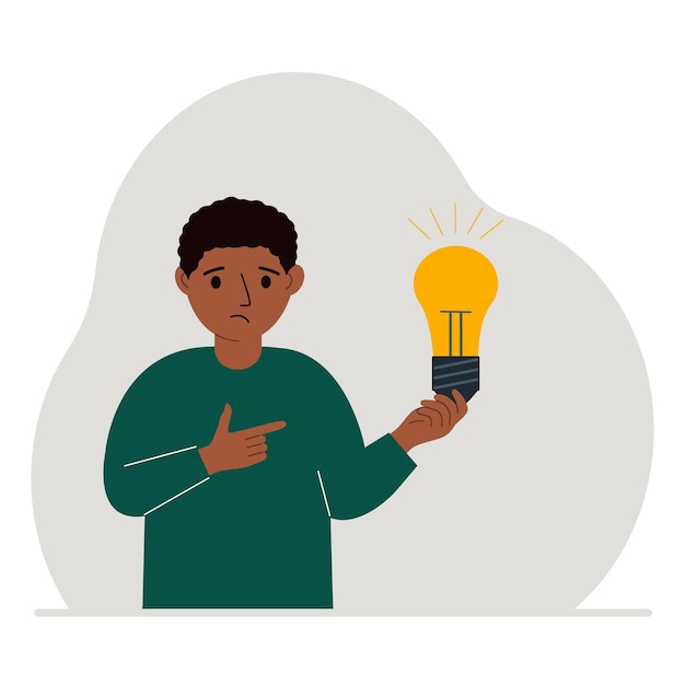 A little boy is holding a light bulb in his hand Concept of idea brainstorming thinking solution eureka bingo homework or find answer