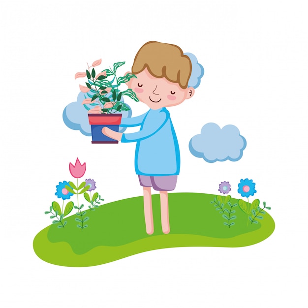 Little boy lifting houseplant in the landscape