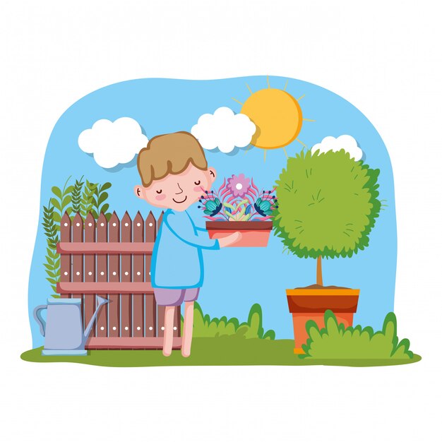 Little boy lifting houseplant with fence and tree