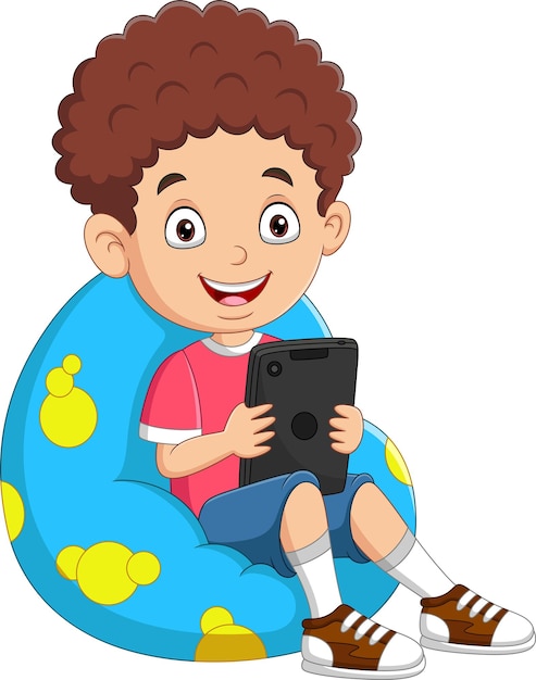 little boy playing tablet on big pillow