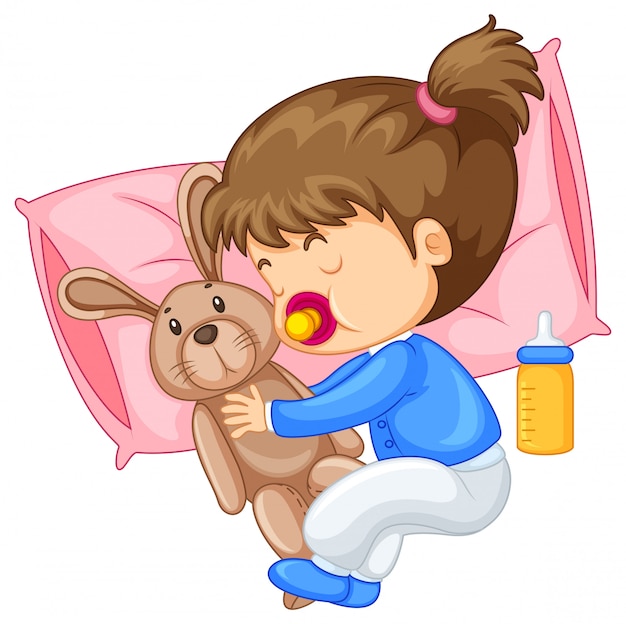 Little girl hugging rabbit in bed