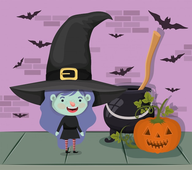 Маленькая девочка с костюмом ведьмы и котлом и метлой