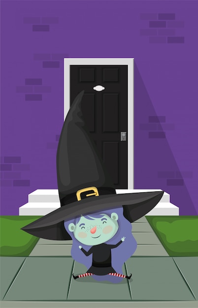 Little girl with witch costume in the house door