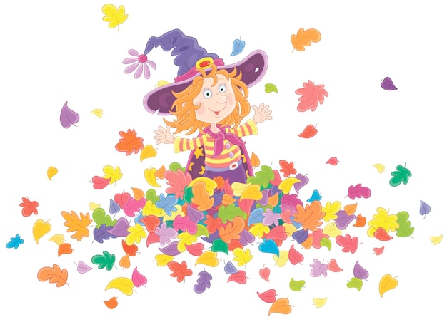 Little Halloween witch affably smiling, playing with colorful fallen leaves and tossing them up