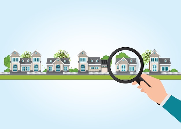 Magnifying glass in human hand with house icon