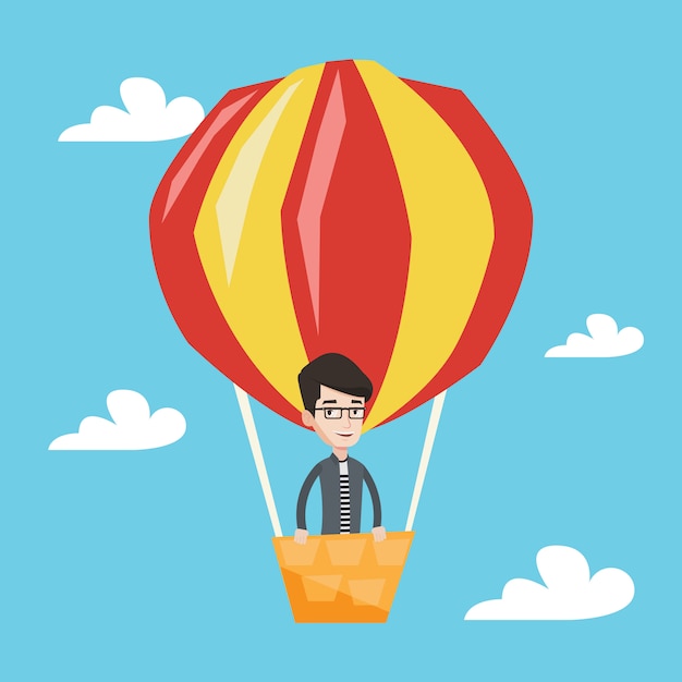 Man flying in hot air balloon .