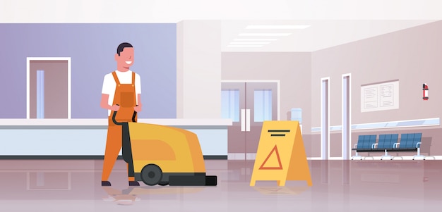 Man holding professional washing machine male cleaner janitor in uniform cleaning service floor care modern hospital waiting hall corridor interior