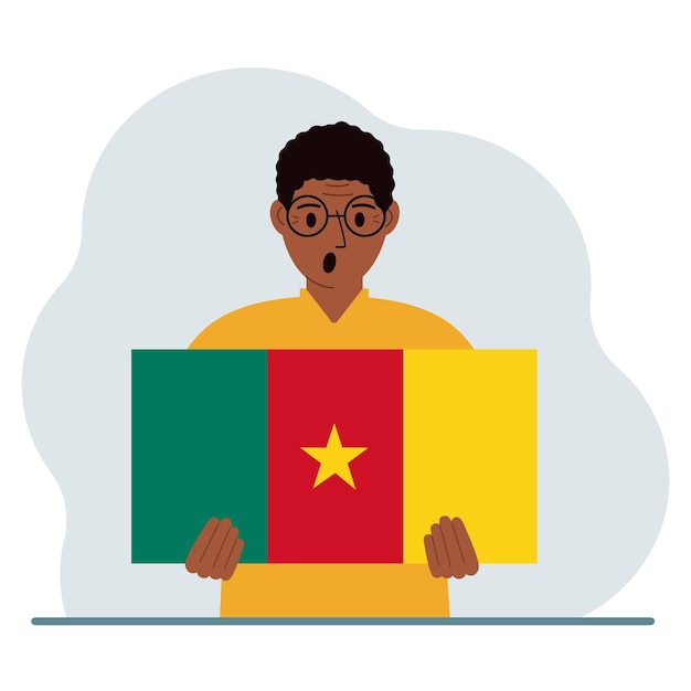 A man holds the flag of Cameroon in his hands The concept of demonstration national holiday or patriotism Nationality