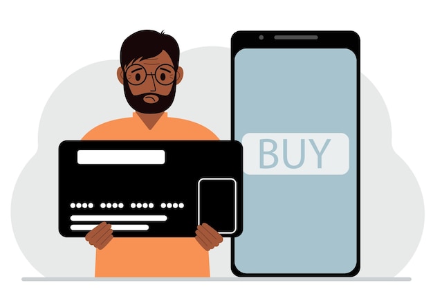 A man holds a huge credit card next to a smartphone with a Buy button on the screen The concept of online payments with payment via mobile phone