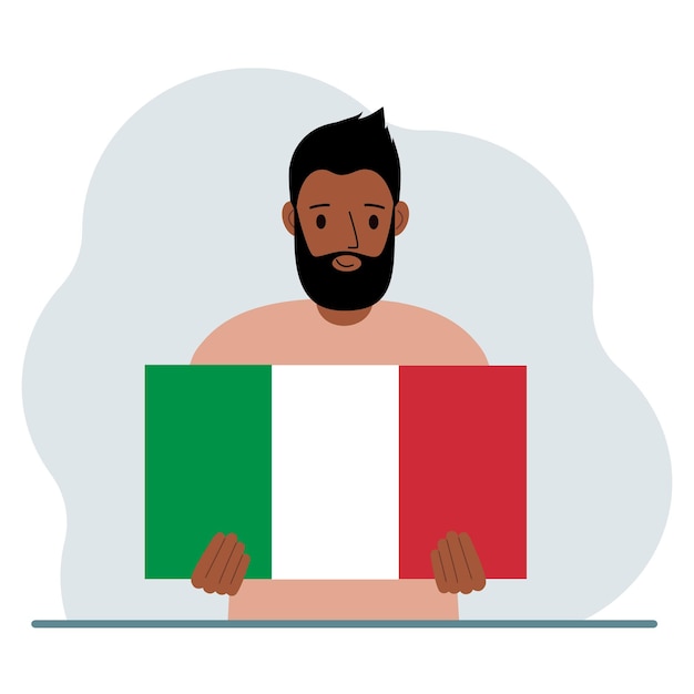 A man holds an Italian flag in his hands The concept of demonstration national holiday or patriotism