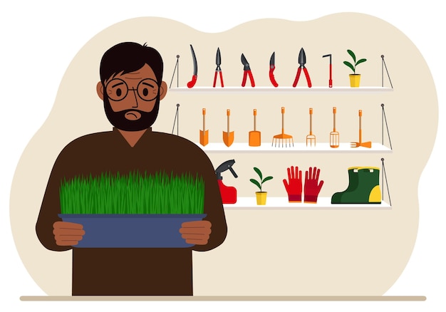 A man holds a plant in his hands against the background of gardening tools Gardening concept