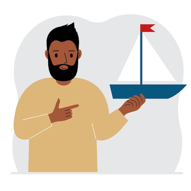 Мужчина держит в руке парусную яхту Понятия свободы надежды и большие планы Хобби спорт или бизнес