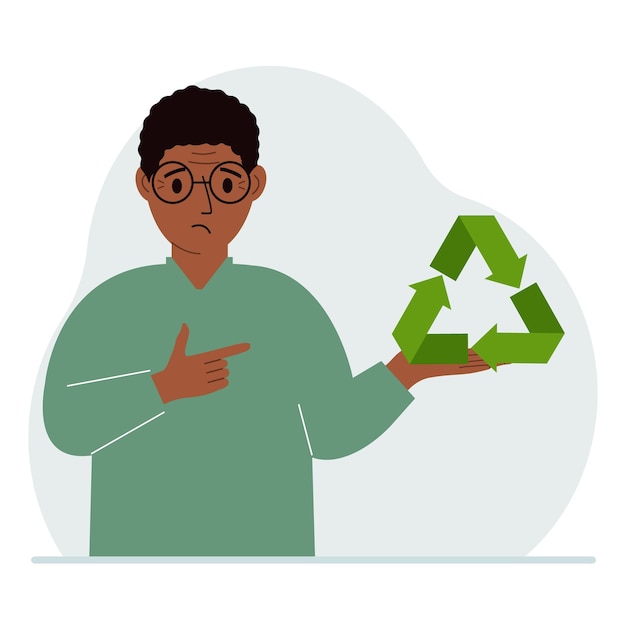 Un uomo tiene in mano un segno verde di riciclo o ecologia