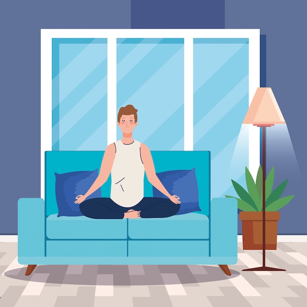 man meditating in the living room, sitting in couch