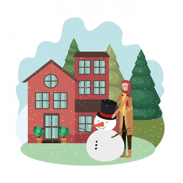 Man met sneeuwpop en huis in de winter