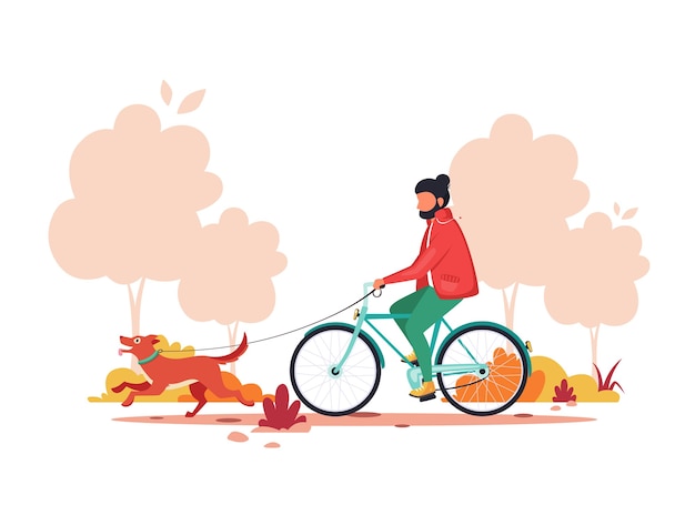 Man riding bike with dog in autumn park. Outdoor activity concept.