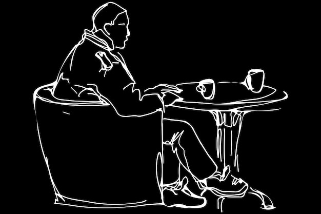 Man at the round table in a cafe drinking coffee