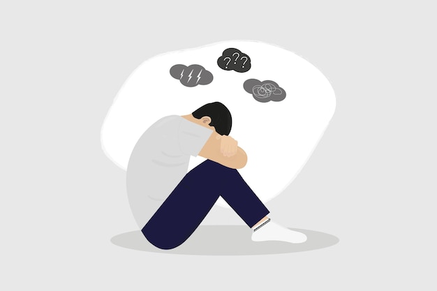 a man sitting with his head down and the question marks above his head.