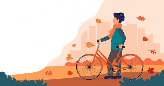 Uomo con una bici in autunno.