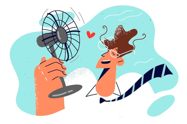 Man with electric fan in hand is trying to freshen up after returning from street in hot summer weather Guy in business clothes uses fan due to lack of air conditioning in office