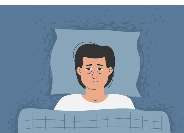 a man with wide eyes is lying in bed, he can't sleep.