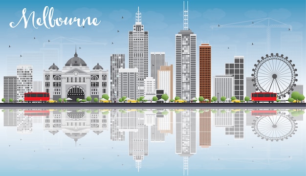 Melbourne skyline met grijs gebouwen, blauwe hemel en reflecties.