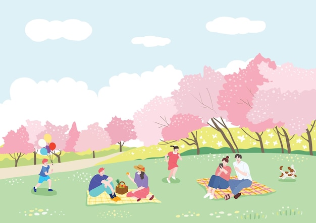 Mensen genieten van een picknick op het gras op een zonnige lentedag wanneer de kersenbloesems in volle bloei staan