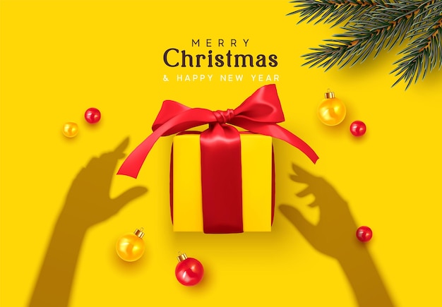 Merry christmas and happy new year. background with realistic gifts box. silhouette shadow from hands holds xmas present. yellow with red ribbon gift surprise, golden baubles, balls, fir pine branch