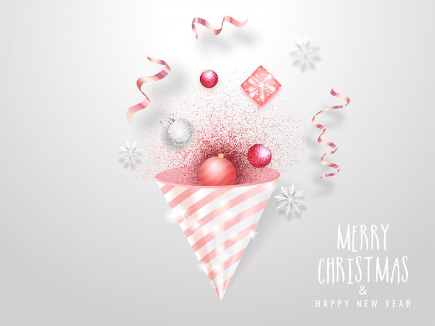 Cartolina d'auguri di celebrazione di buon natale e felice anno nuovo con popper partito, palline, fiocco di neve e confezione regalo su bianco.