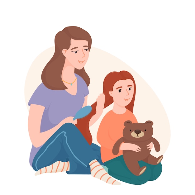 Mom combing her little daughter hair with a brush, both sitting on the floor. Mother and daughter spending time together, brushing hair