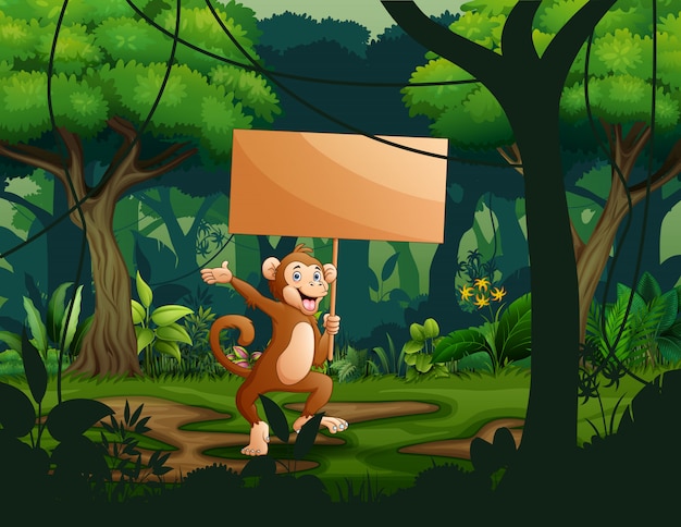 A monkey holding an empty wooden sign board in the forest