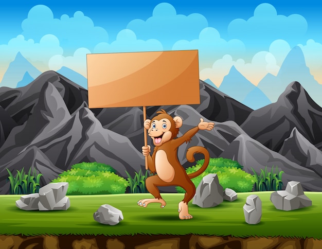 A monkey holding a wooden sign board in the mountain