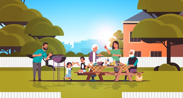 Multi generation family preparing hot dogs on grill happy grandparents parents and children having fun backyard picnic barbecue party concept flat full length horizontal