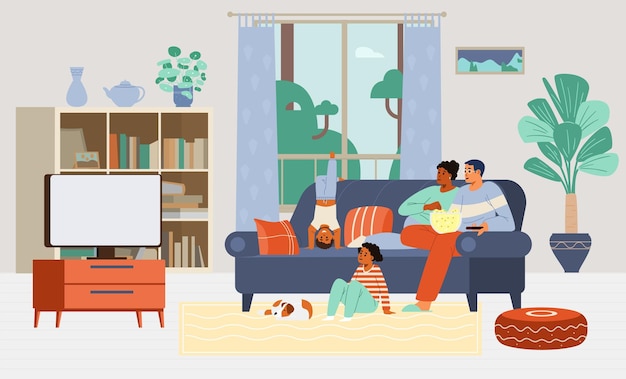 Multiracial family with two kids and a dog watching TV together sitting on the couch at home