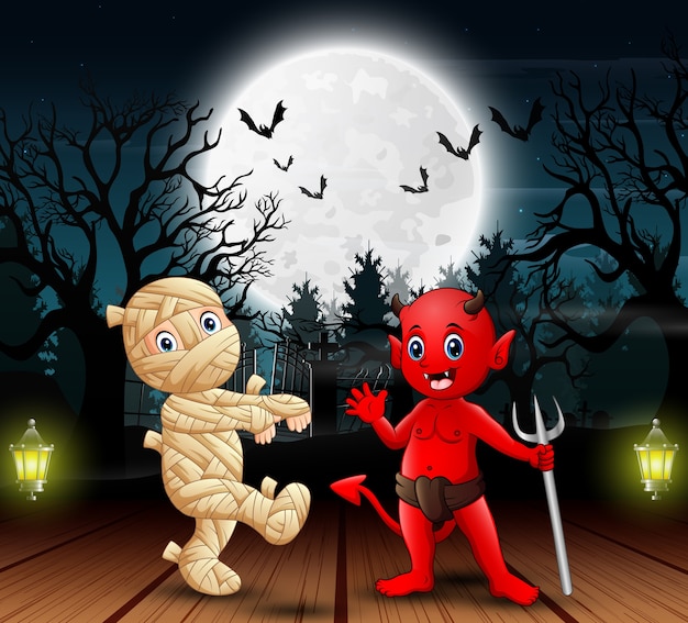 Mummy and red devil outdoors in the night