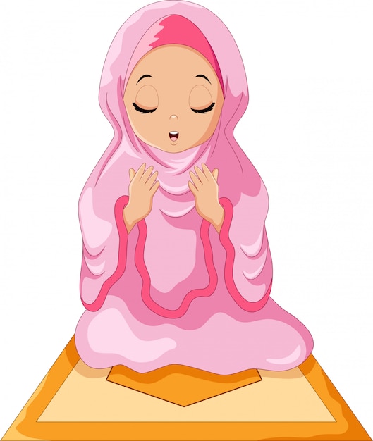 Muslim girl sitting on the prayer rug while praying