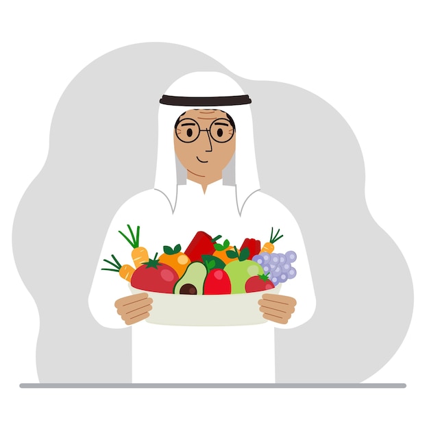 A muslim man with a large plate of healthy organic food vegetables and fruits The concept of healthy food healthy lifestyle vegetarianism agriculture