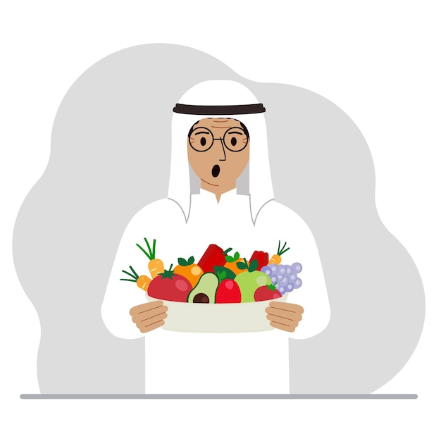 A muslim man with a large plate of healthy organic food vegetables and fruits The concept of healthy food healthy lifestyle vegetarianism agriculture