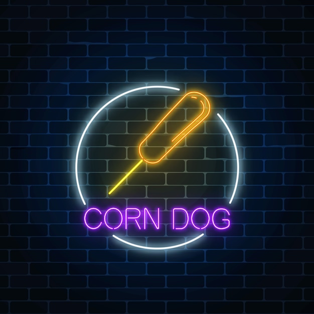 Neon glowing sign of corn dog in circle frame on a dark brick wall