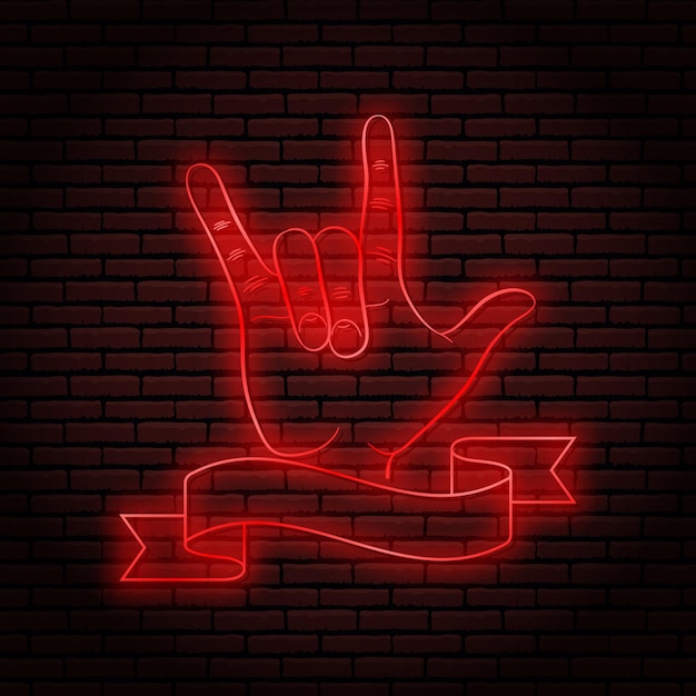 Insegna al neon con un bagliore rosso gesto della mano rock n roll su uno sfondo di muro di mattoni per il tuo design