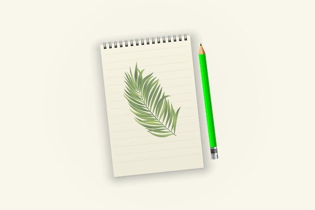 A notebook with a green pencil and a palm leaf on it.