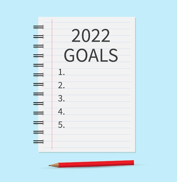 Notebook with the words goals 2022 Notebook paper for text with pencil on blue background