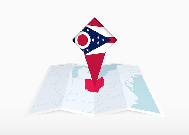 オハイオ州は折りたたまれた紙の地図に描かれ,オハイオ州の旗が付いている位置標識が付いています